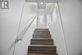 Waterloo apartment for rent - A staircase with wooden steps and white walls.