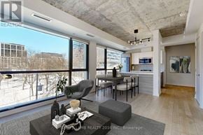 Toronto (Waterfront Communities) condo for rent - A modern living room with a large window overlooking a snowy landscape.