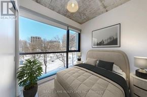 Toronto (Waterfront Communities) condo for rent - A bedroom with a large bed and a potted plant.
