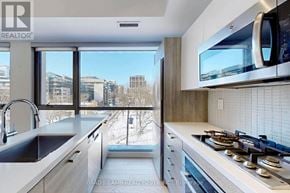 Toronto (Waterfront Communities) condo for rent - A modern kitchen with a view of the city.