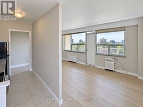 Toronto (Annex) condo for rent - A room with a window overlooking a cityscape is for sale.