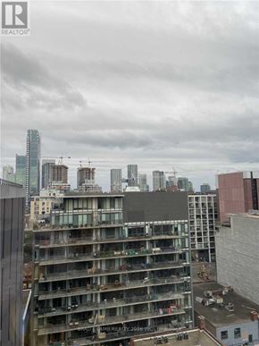 Toronto (Waterfront Communities) condo for rent - A construction site with a building under construction in the foreground and other buildings in the background.