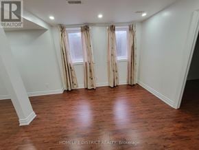 Ajax (Northwest Ajax) apartment for rent - A room with wooden floors and a window with curtains.