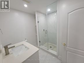 Ajax (Northwest Ajax) apartment for rent - A white bathroom with a sink, mirror, and shower.