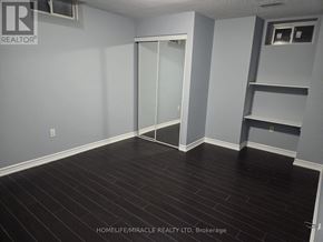 Brampton (Toronto Gore Rural Estate) apartment for rent - A room with a sliding door and wooden flooring.