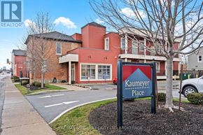 Niagara Falls (Chippawa) condo for rent - A sign for Kaumeyer Place stands in front of a building.