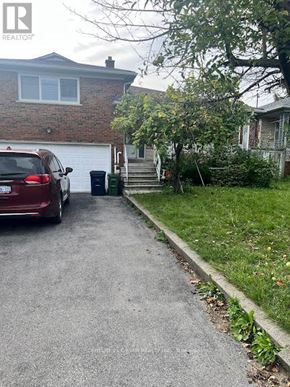 Toronto (Clairlea-Birchmount) apartment for rent - A red car is parked on a driveway leading to a house.
