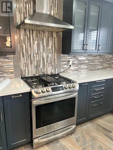 Toronto (Clairlea-Birchmount) apartment for rent - A modern kitchen with a stove and cabinets.
