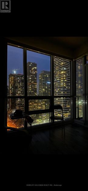 Toronto (Mimico) condo for rent - A room with a view of the city at night.
