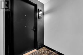 Ottawa apartment for rent - A black door with a sign above it in a room.