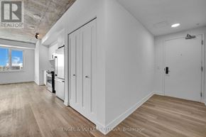 Ottawa apartment for rent - A white room with a wooden floor and a window.