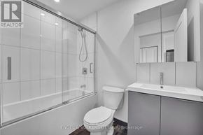 Ottawa apartment for rent - A bathroom with a toilet, sink, and shower.
