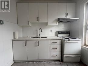 Toronto (Kensington-Chinatown) apartment for rent - A kitchen with white cabinets and appliances.