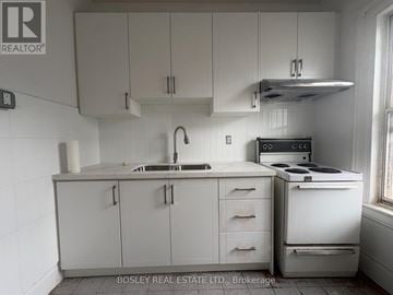 Toronto (Kensington-Chinatown) apartment for rent - A kitchen with white cabinets and appliances.