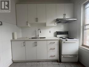 Toronto (Kensington-Chinatown) apartment for rent - A kitchen with white cabinets and appliances is on the market with Bosley Real Estate.