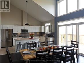 Collingwood townhouse for rent - A modern kitchen with a dining table set for a meal.