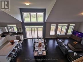 Collingwood townhouse for rent - A modern open-concept living room with a kitchen and dining area.