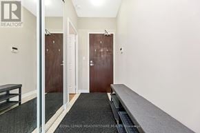 Mississauga (City Centre) condo for rent - A hallway with a bench and a door at the end.