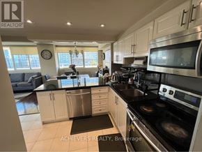 Mississauga (Mississauga Valleys) condo for rent - A kitchen with a stove top oven and a microwave.