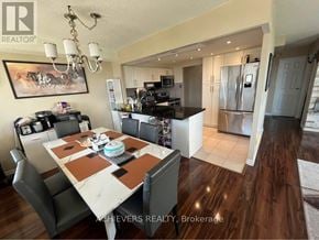 Mississauga (Mississauga Valleys) condo for rent - A dining room with a table set for four and a kitchen in the background.