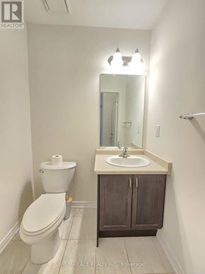 Brant (Paris) townhouse for rent - A white toilet sits next to a sink in a small bathroom.