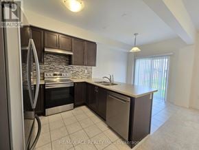 Brant (Paris) townhouse for rent - A kitchen with a stone backsplash and stainless steel appliances.