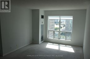 Toronto (Woburn) condo for rent - A room with a large window and a door leading to another room.