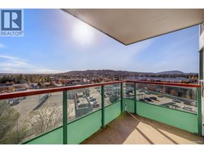 Coquitlam apartment for rent - A balcony with a view of a parking lot and trees.