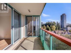 Coquitlam apartment for rent - A balcony with glass railings and sliding doors overlooks a cityscape.