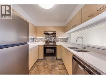 Coquitlam apartment for rent - A modern kitchen with wooden cabinets and stainless steel appliances.