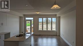 Brampton (Bram West) townhouse for rent - A real estate office is showing a new home with a kitchen and a view of the backyard.