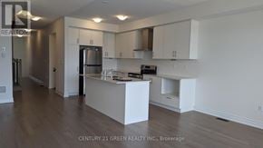 Brampton (Bram West) townhouse for rent - A kitchen with white cabinets and a wooden floor.