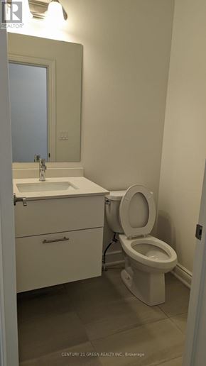 Brampton (Bram West) townhouse for rent - A white toilet sits next to a sink in a small bathroom.
