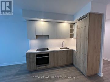 Vaughan (Concord) condo for rent - A kitchen with wooden cabinets and a sink.