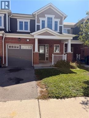 Cambridge townhouse for rent - A house with a garage and a driveway in front.