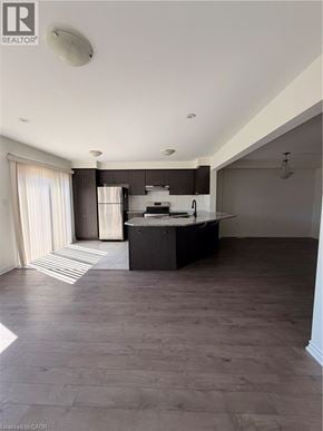 Cambridge townhouse for rent - A spacious kitchen with dark wood floors and a large island.