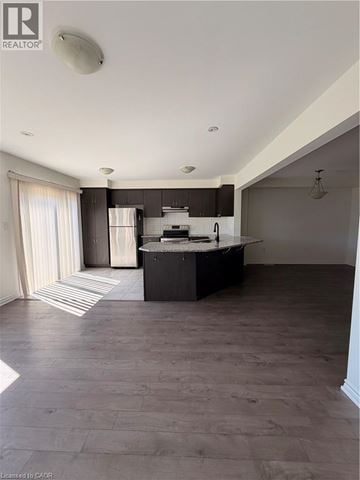 Cambridge townhouse for rent - A spacious kitchen with dark wood floors and a large island.