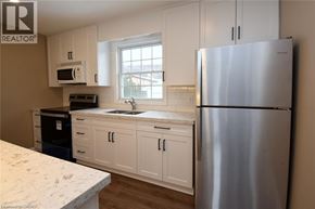 Hamilton apartment for rent - A bathroom with a toilet, sink, and window.