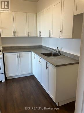 Ottawa condo for rent - A kitchen with white cabinets and a sink.