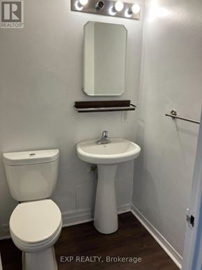 Ottawa condo for rent - A white toilet and sink in a small bathroom.