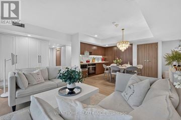 Toronto (Waterfront Communities) condo for rent - A modern living room with a grey sofa and a coffee table.