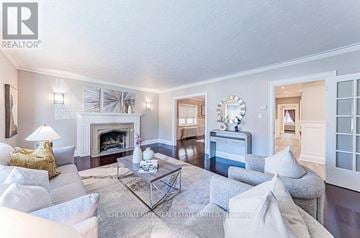 Toronto (Yonge-Eglinton) triplex for rent - A living room with a fireplace and a couch.
