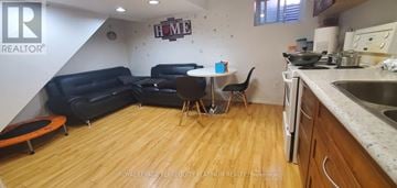 Toronto (Woodbine-Lumsden) apartment for rent - A kitchen with a table and chairs in the middle of the room.