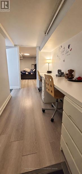 Toronto (Woodbine-Lumsden) apartment for rent - A long hallway with a desk and a bed in the background.