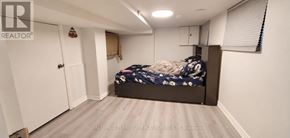 Toronto (Woodbine-Lumsden) apartment for rent - A bedroom with a bed, a closet, and a window with blinds.