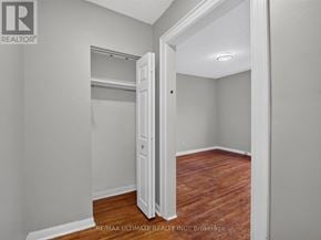 Toronto (The Beaches) multi-family for rent - A room with a white door and a wooden floor.