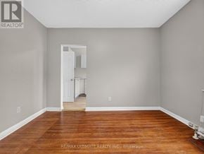 Toronto (The Beaches) multi-family for rent - A room with wooden floors and a white door.