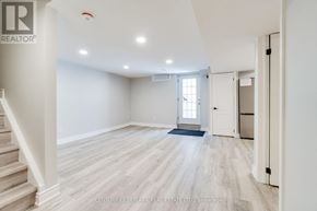 Mississauga (Lisgar) apartment for rent - A spacious room with wooden flooring and white walls.