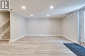 Mississauga (Lisgar) apartment for rent - A spacious room with wooden flooring and a staircase on the left side.