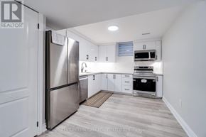 Mississauga (Lisgar) apartment for rent - A kitchen with a refrigerator, microwave, oven, and sink.